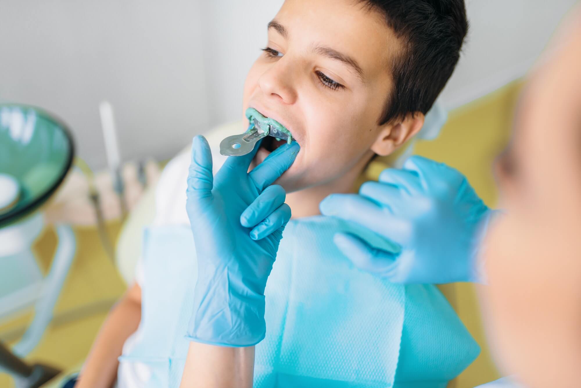 female-dentist-makes-teeth-impression