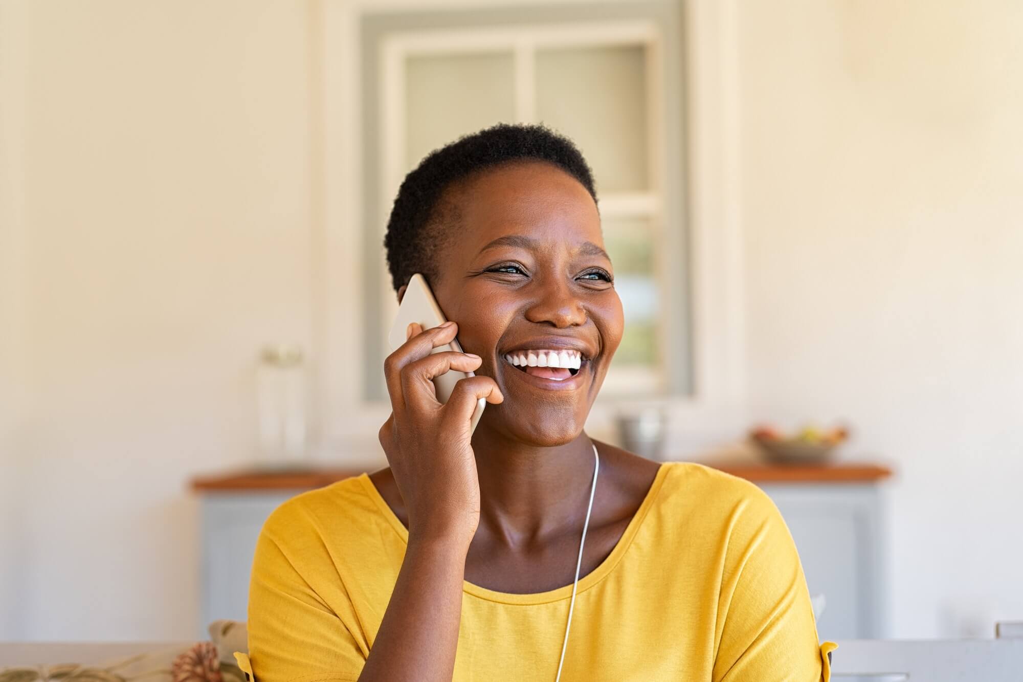 woman-laughing-while-talking-on-phone