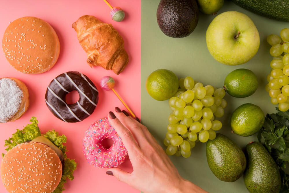 top view unhealthy food versus healthy foodwith hand holding donut